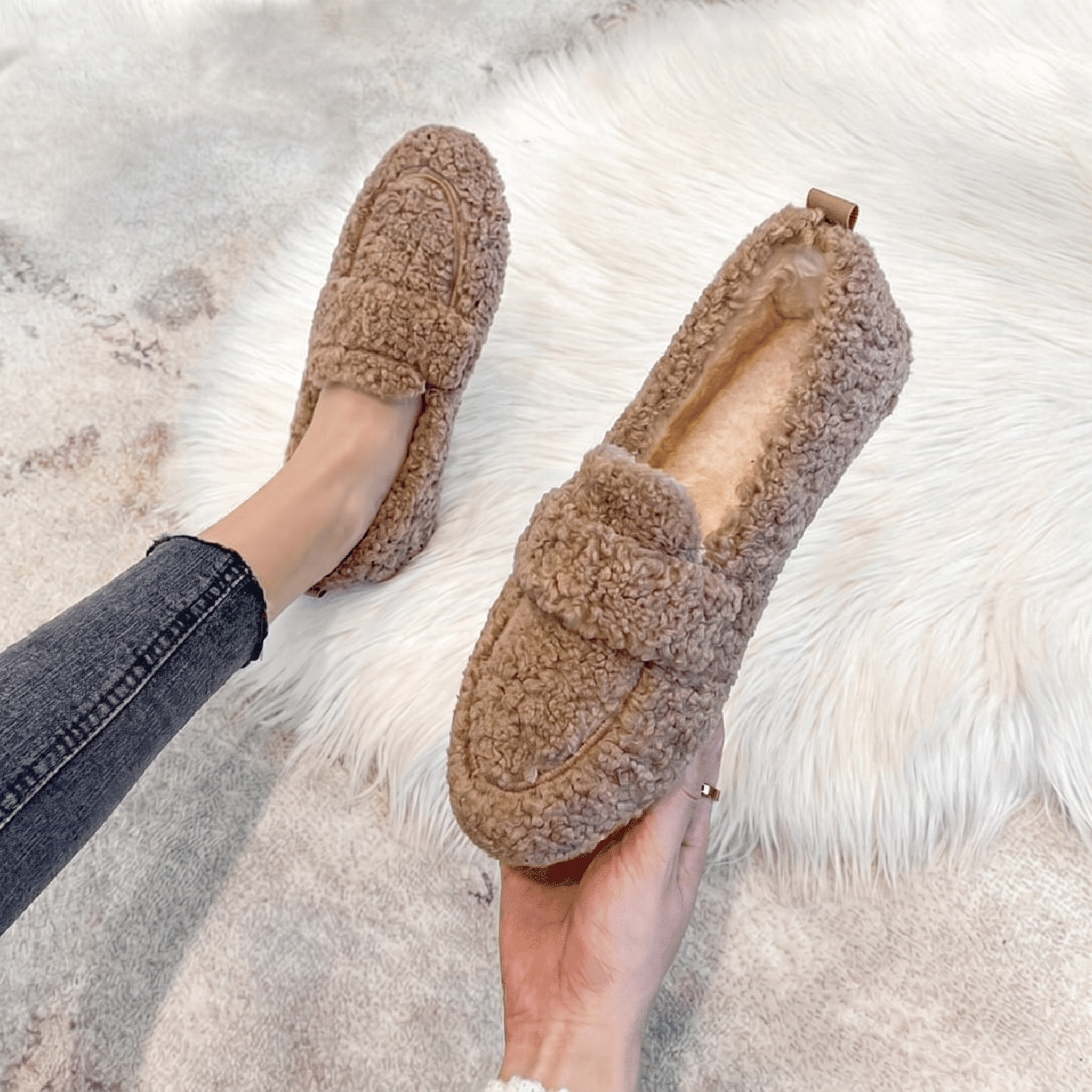 Brown plush teddy slippers worn on a soft fur rug