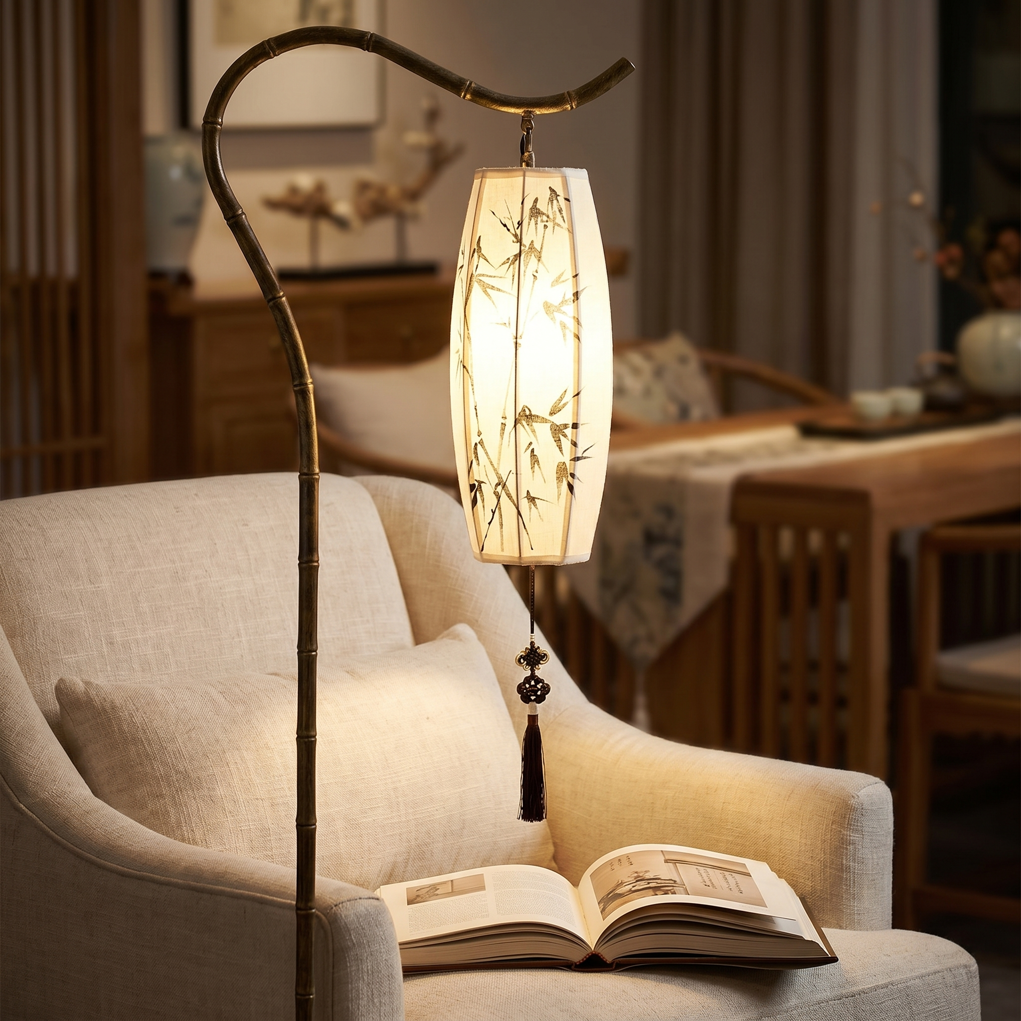 Close view of the Lumina lantern shade glowing over an open book on a chair