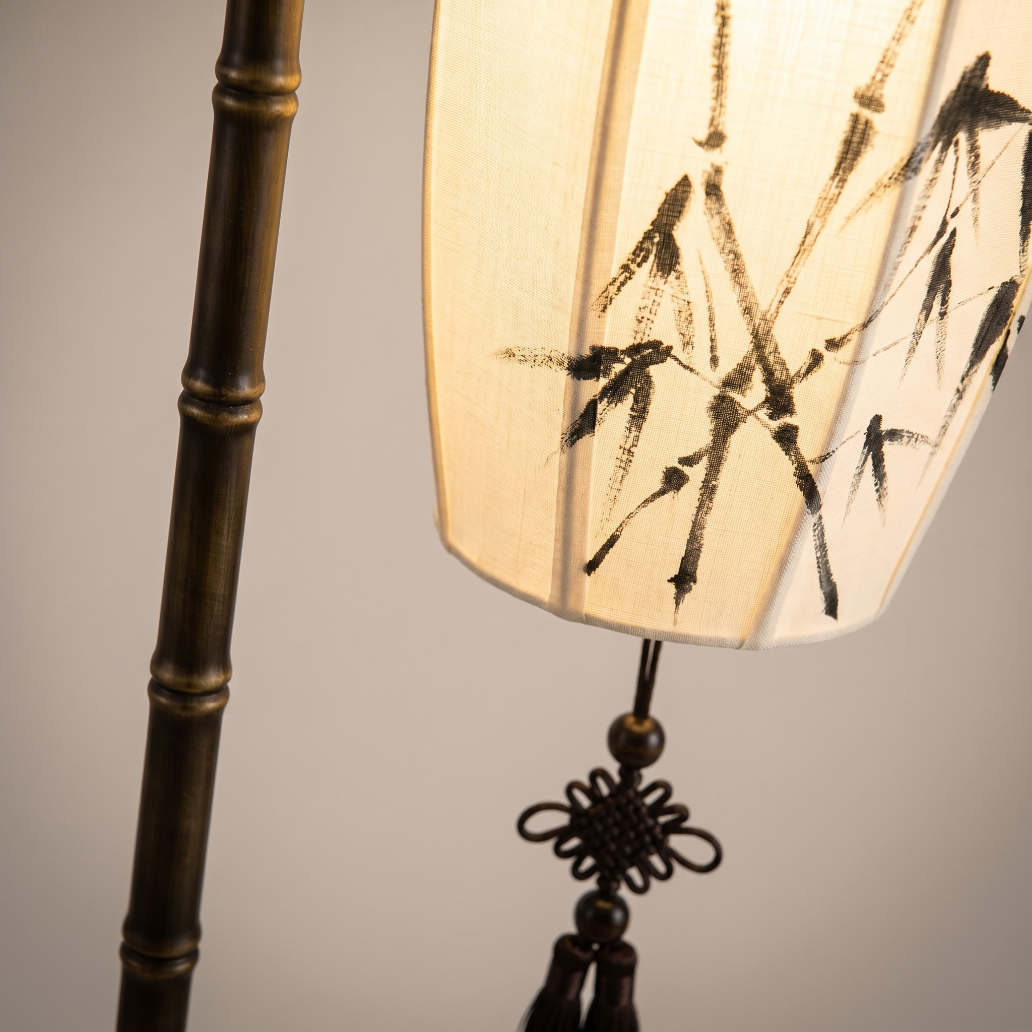 Macro detail of the Lumina cream shade with ink bamboo, bronze bamboo pole and tassel