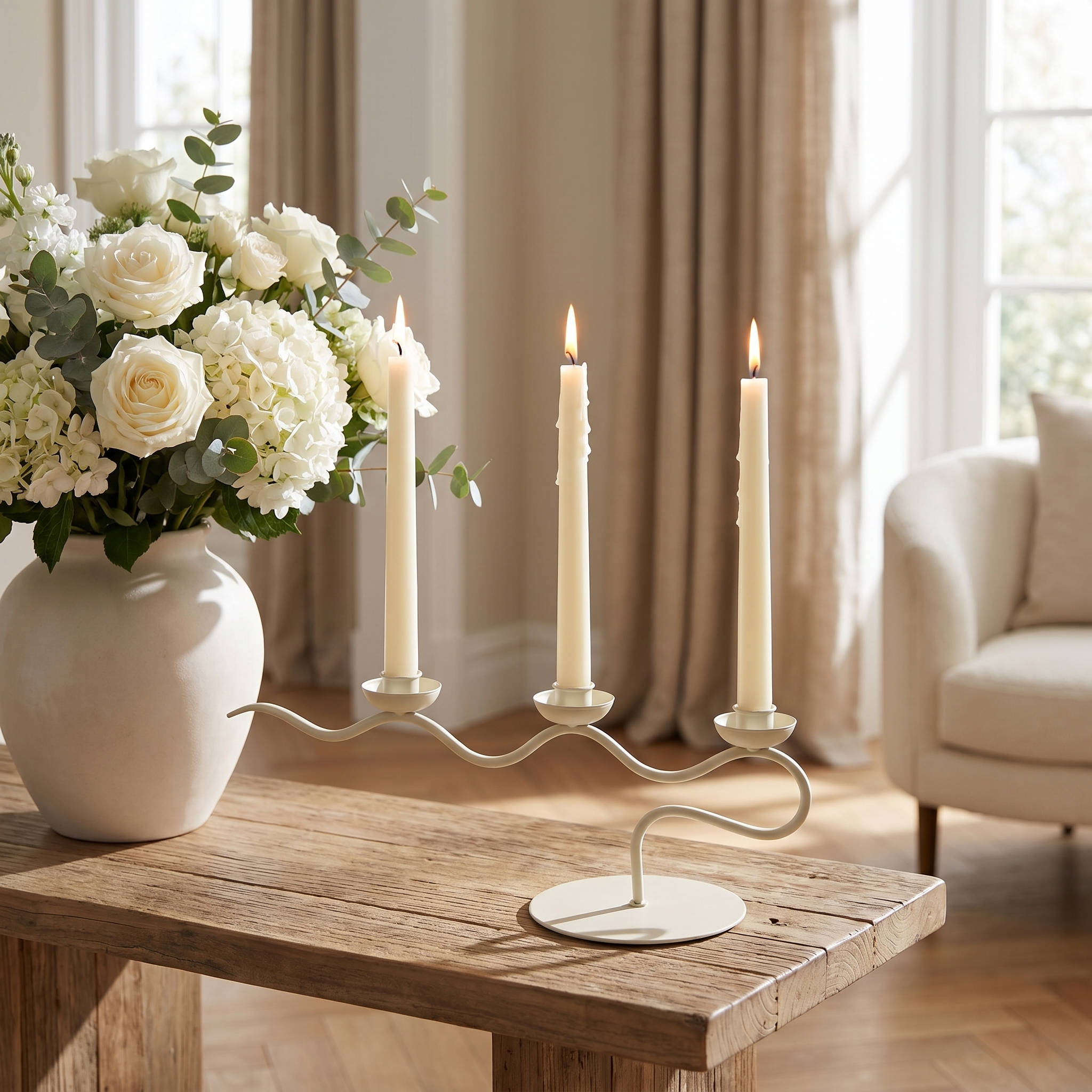 Cream candelabra on a console with blooms