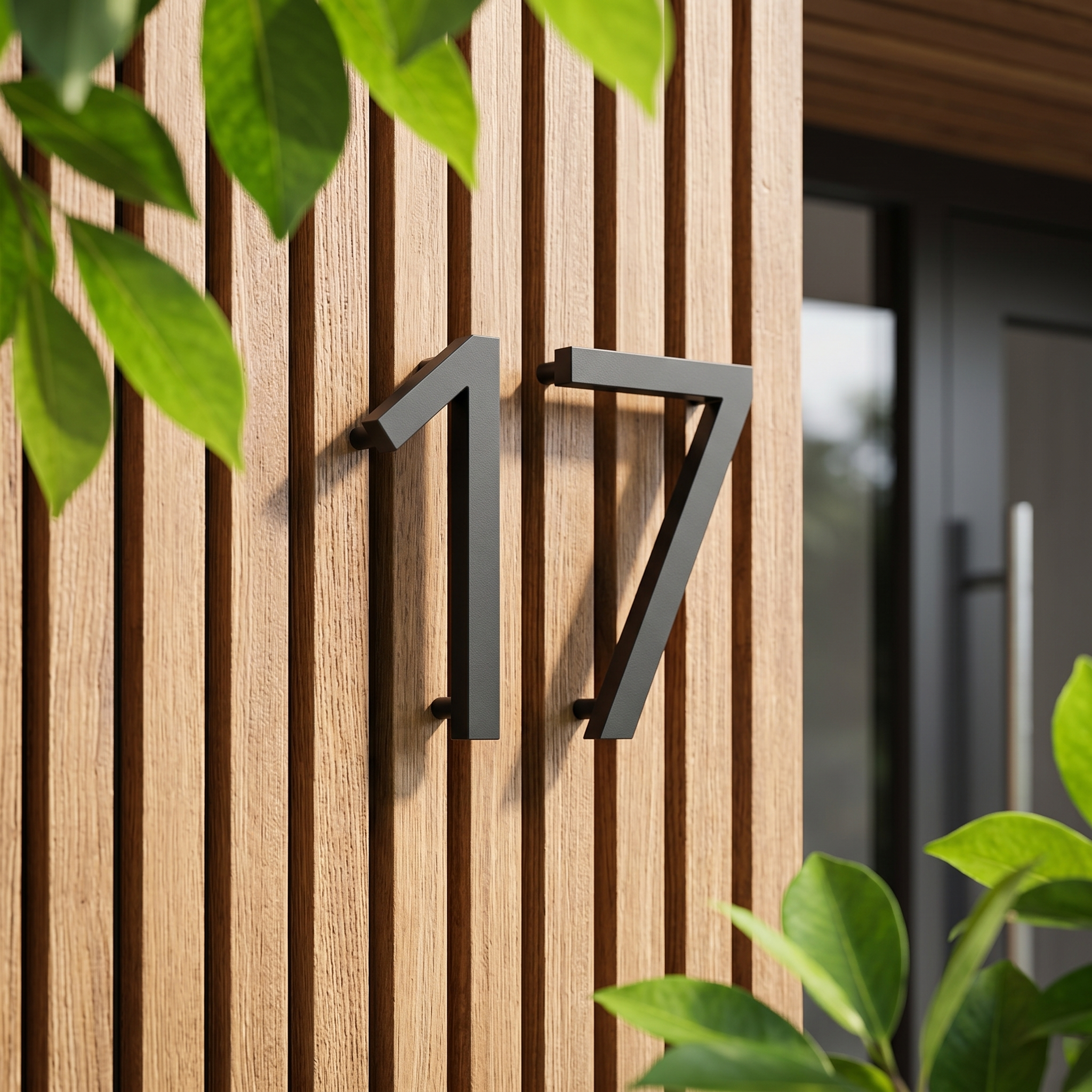 Matte-black house numbers 17 on a wood-slat modern facade