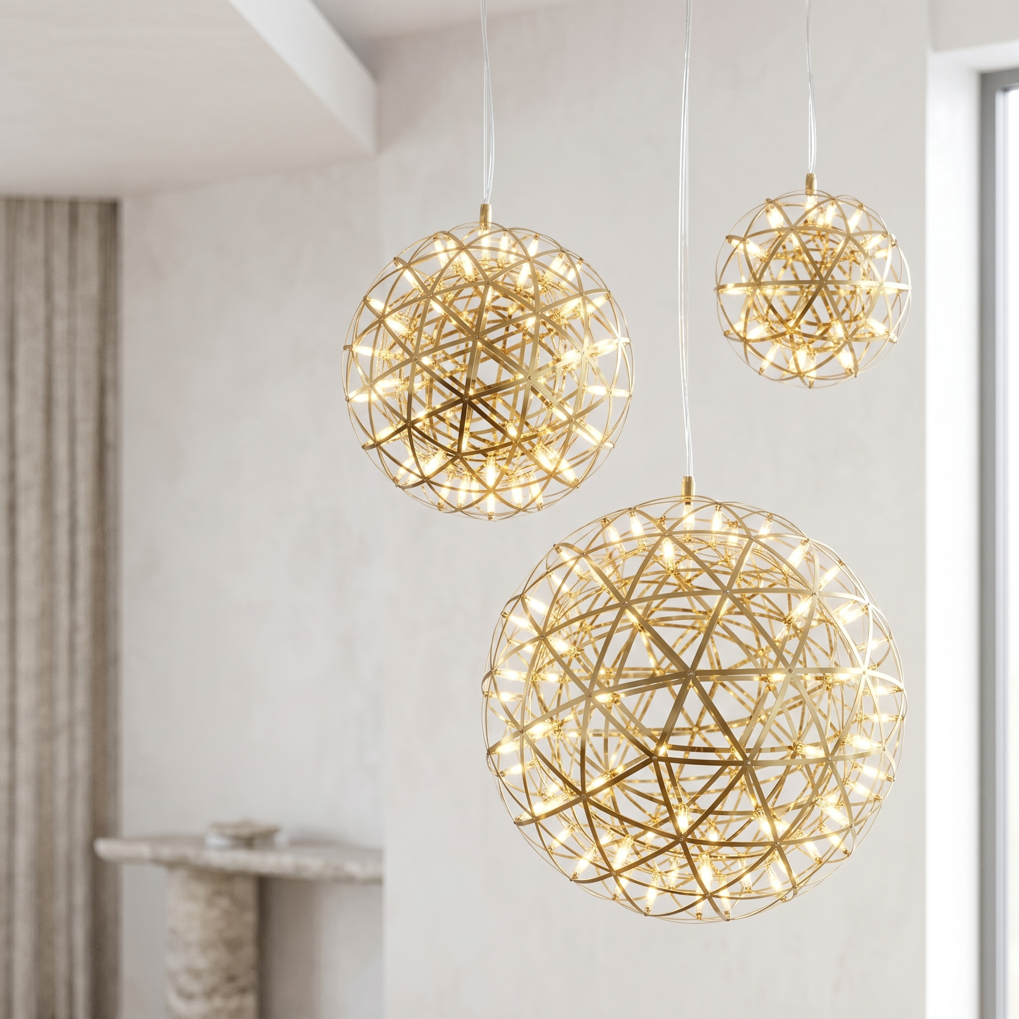 Costellazione gold sphere chandeliers in graduated sizes