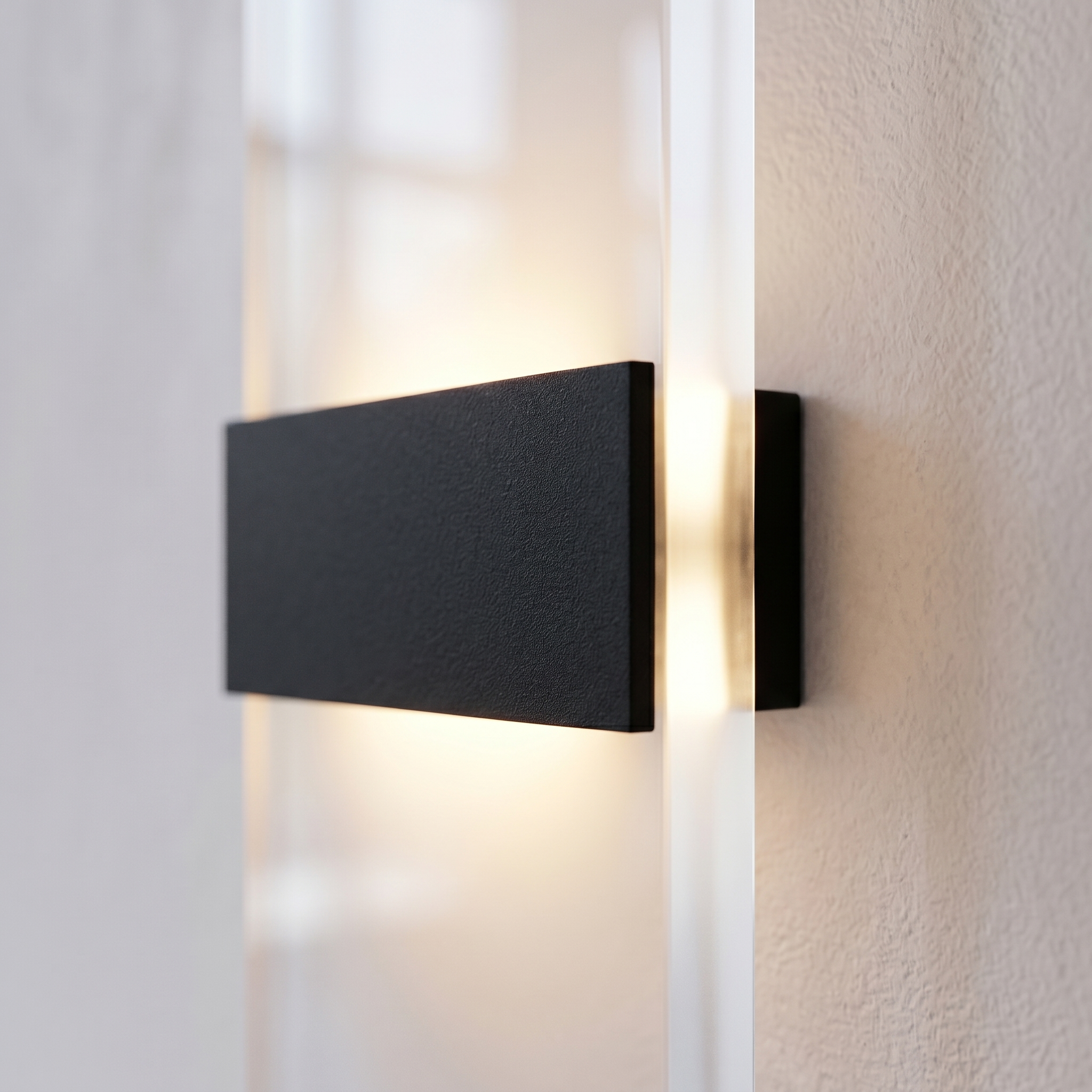 Close-up of the frosted acrylic panel and metal bar glowing warm