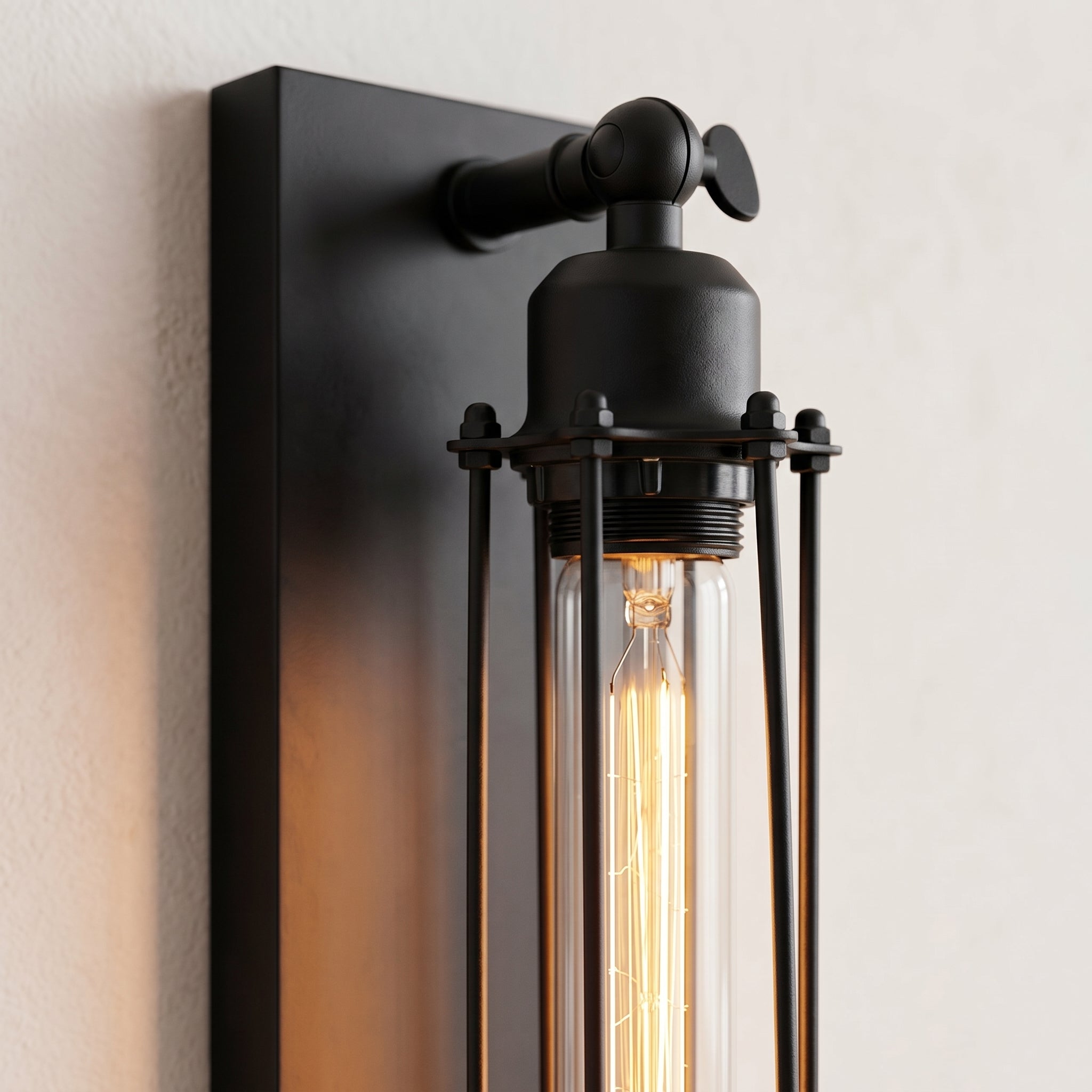 Close-up of the cage and glowing Edison tube of the wall sconce