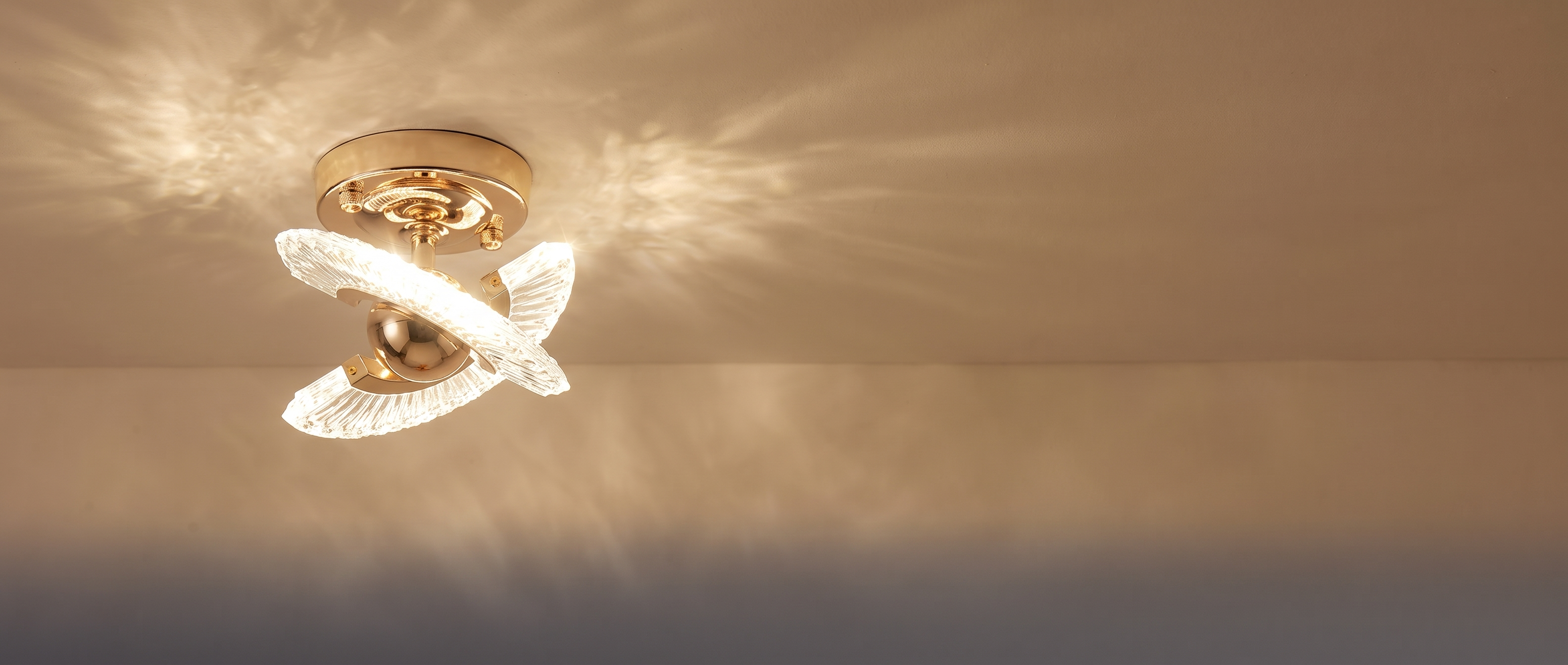 Winged crystal ceiling light glowing on a ceiling