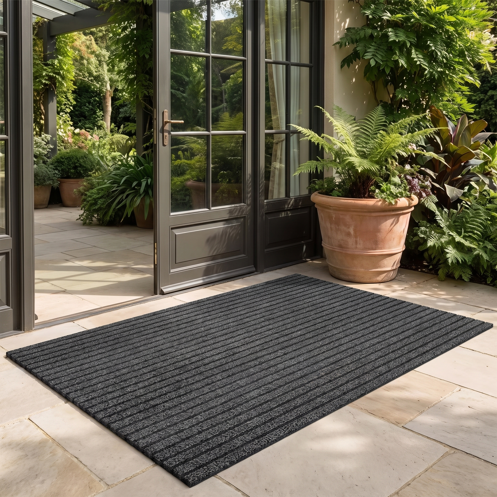 Charcoal gray ribbed doormat at a patio garden door