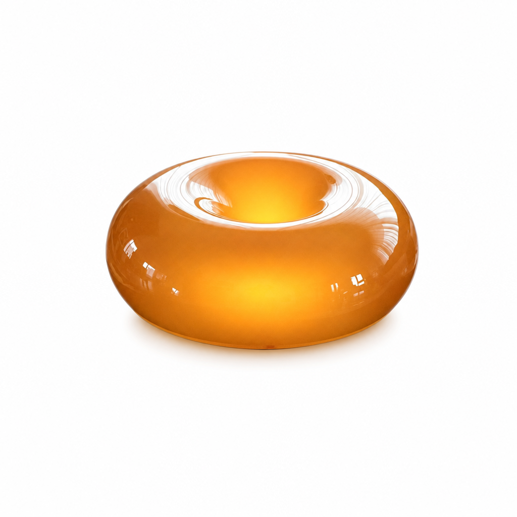 Sole Ambrato amber donut glow lamp, glowing warm amber on white