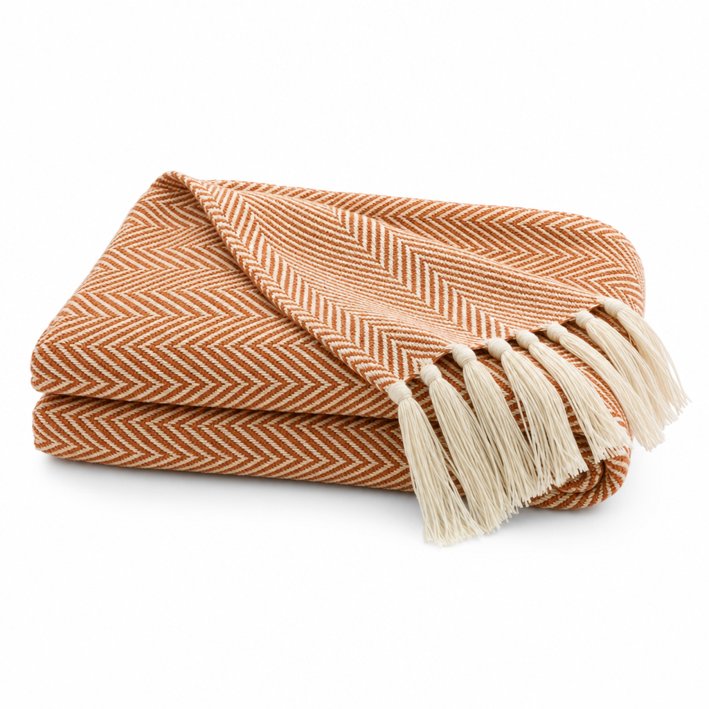 Brezza Marina woven throw blanket in terracotta orange, folded on white