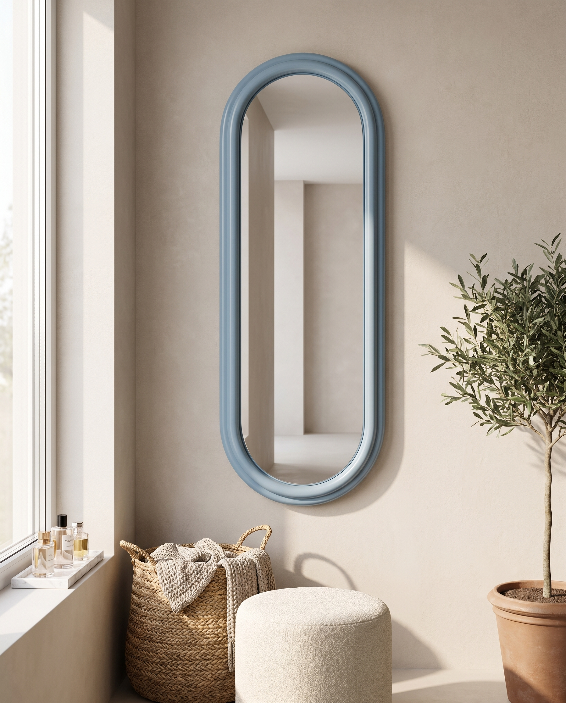Dusty-blue capsule wall mirror in a serene dressing corner