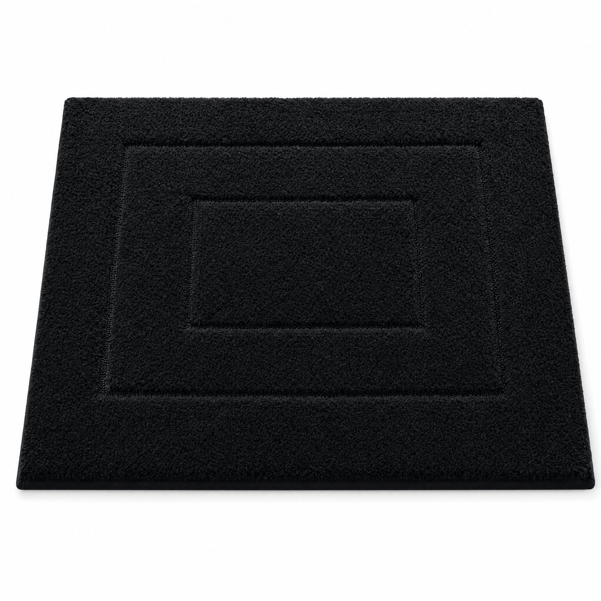 Black plush bath mat on a white background