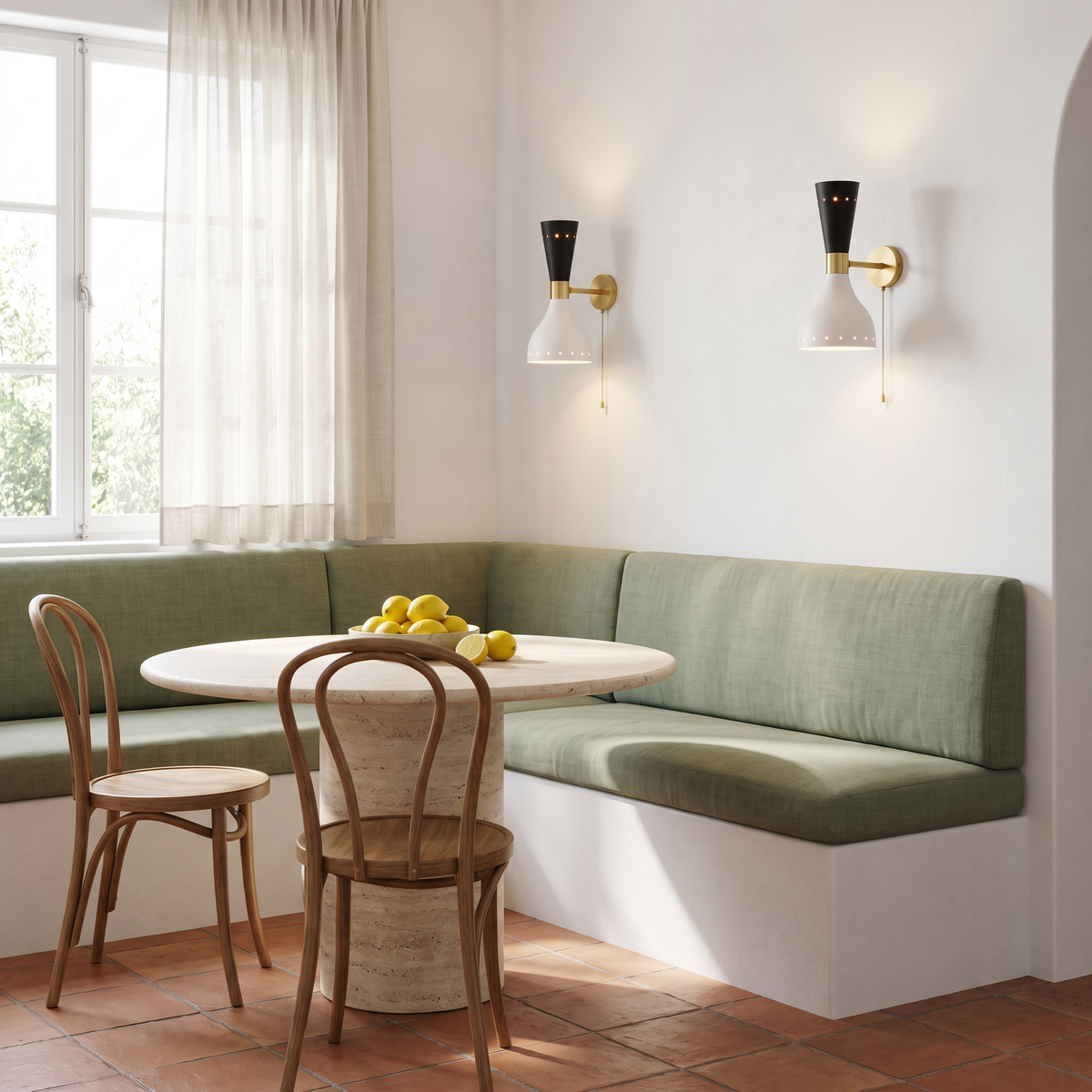 Pair of black and white wall sconces above a sage banquette breakfast nook