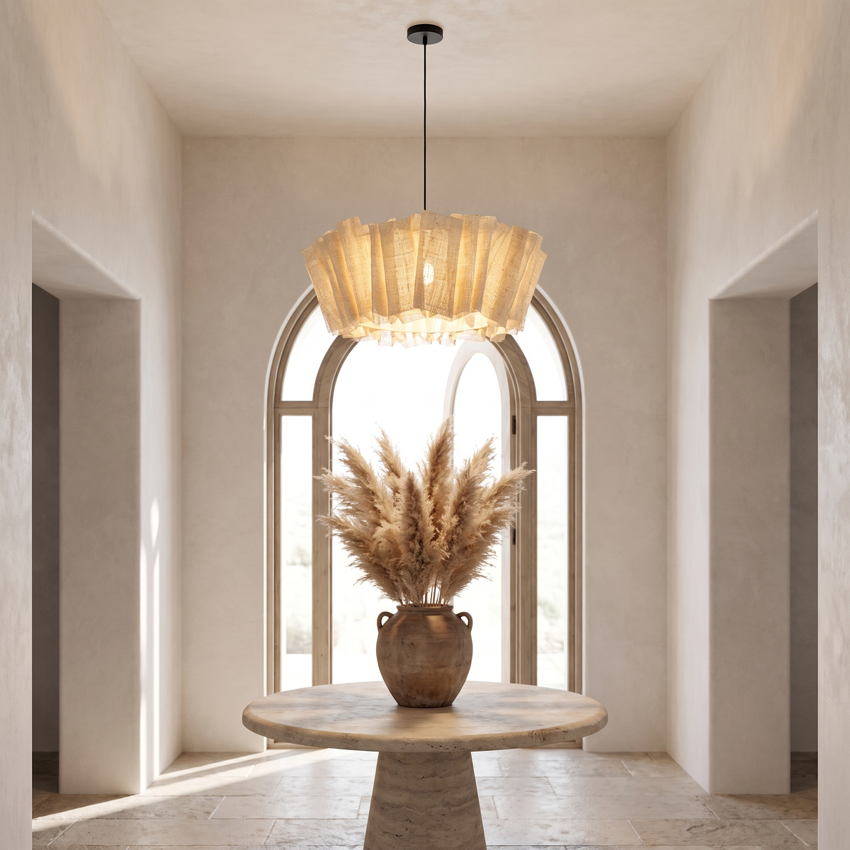 Woven abaca pendant glowing above a round stone table in an entrance hall