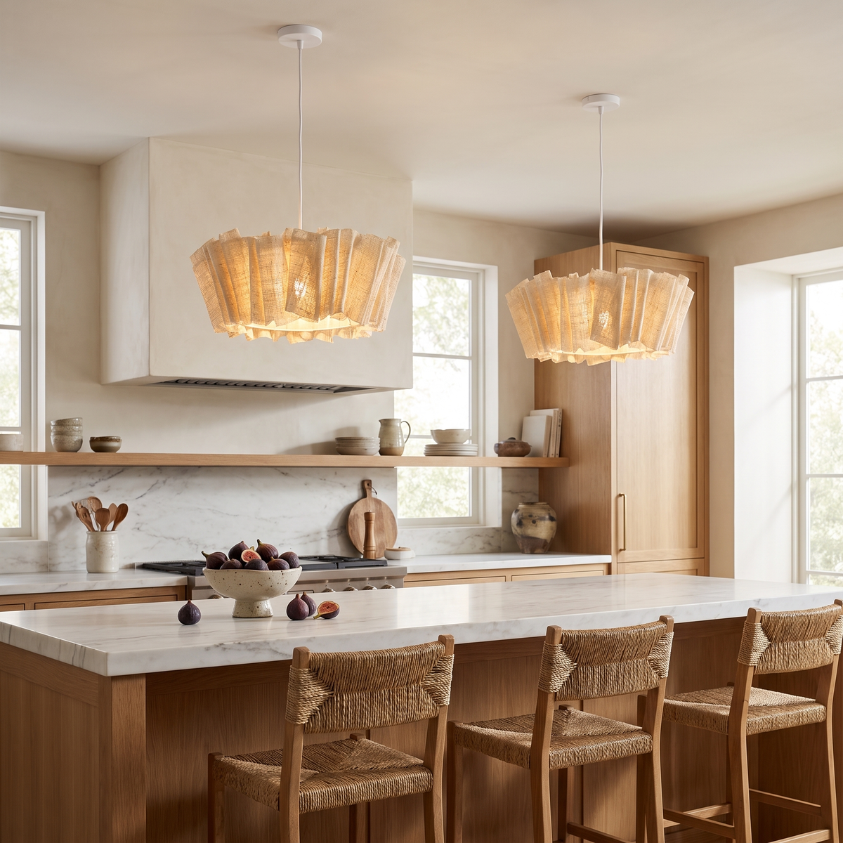 Pair of woven abaca pendants above an oak and marble kitchen island