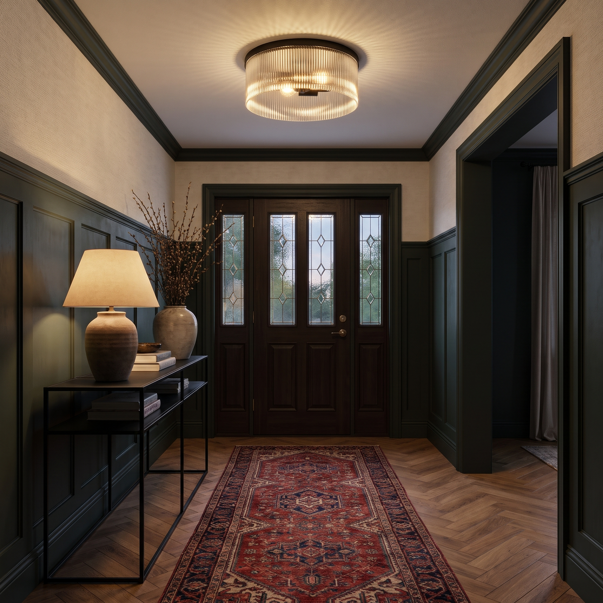 Black ribbed glass flush mount in a dark green entryway with a vintage runner
