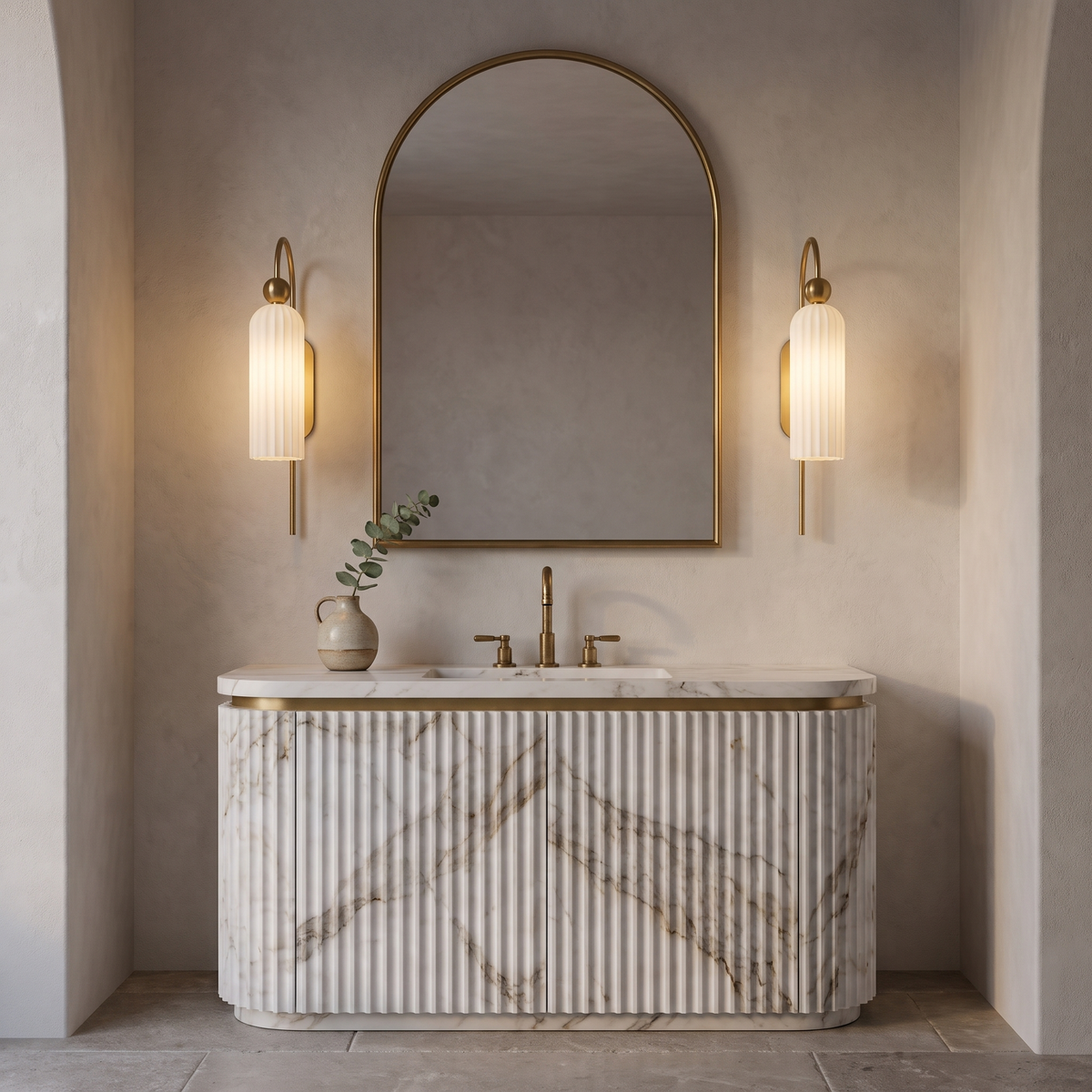 Pair of milk glass gooseneck wall sconces flanking an arched mirror above a fluted marble vanity
