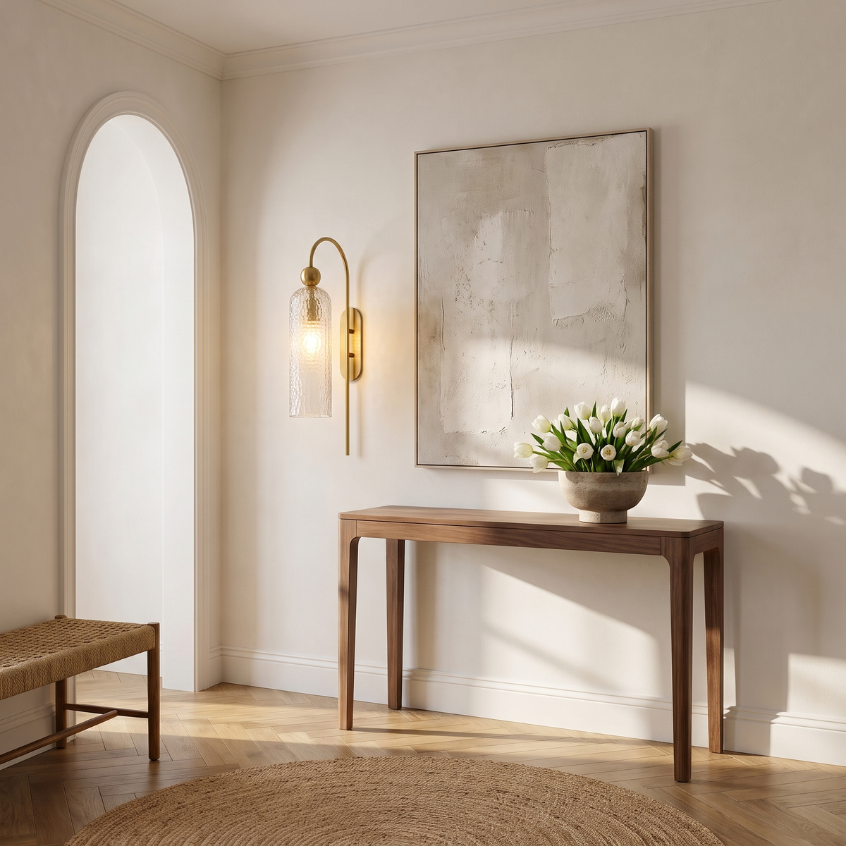 Hammered glass gooseneck wall sconce beside an abstract artwork above a walnut console in an entrance hall