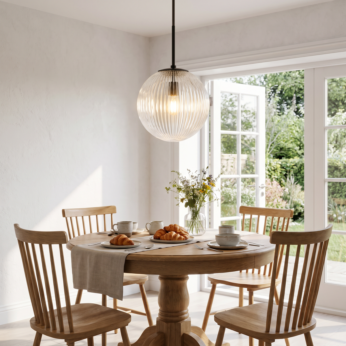 Bronze ribbed glass globe pendant over a round breakfast table