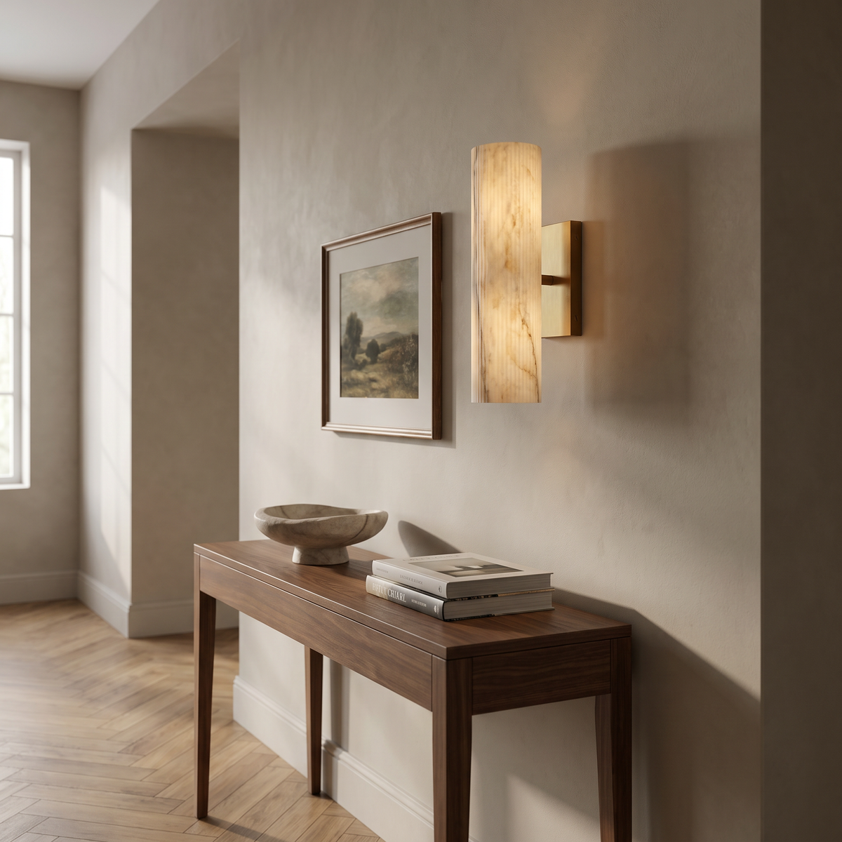 Brass marble tube sconce above a walnut console in a hallway