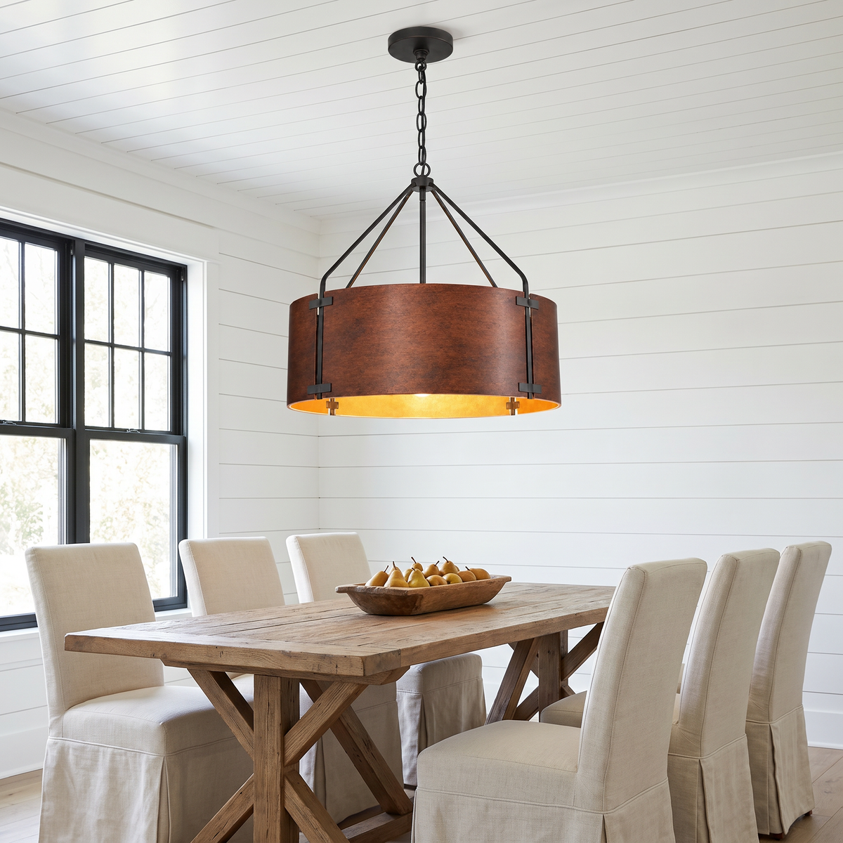 Large Tamburo bronze drum chandelier over a farmhouse dining table