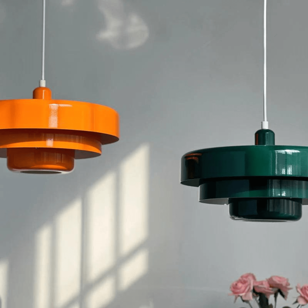 Orange and green macaron pendant lights on a sunlit wall