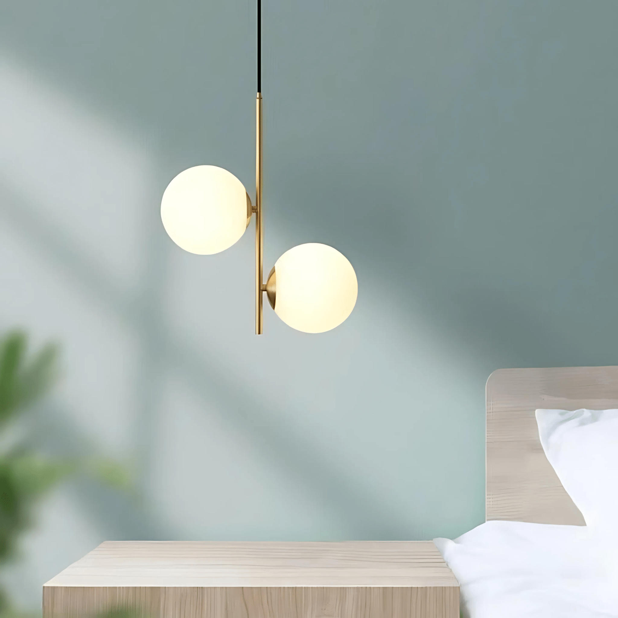 Close-up of the glowing opal glass globes of the Perla Pendant
