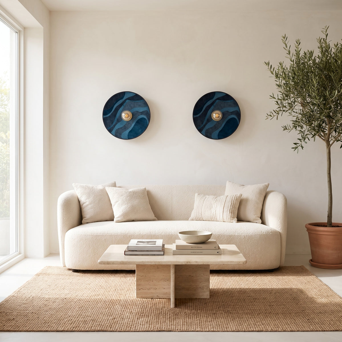 Pair of Luna Tessuta wall sconces in Midnight Blue Waves above a boucle sofa