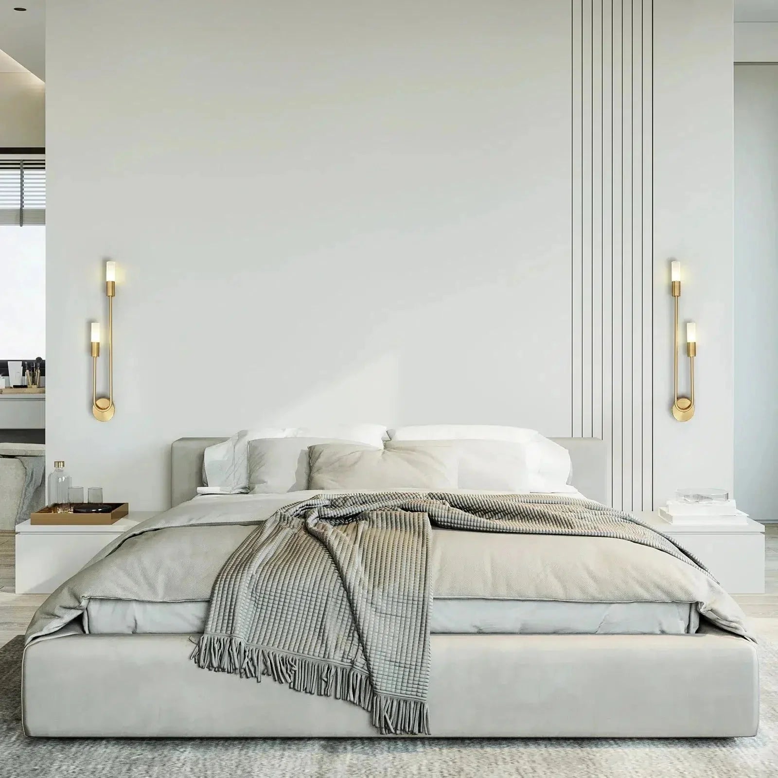 Gold curved wall sconces flanking a bed