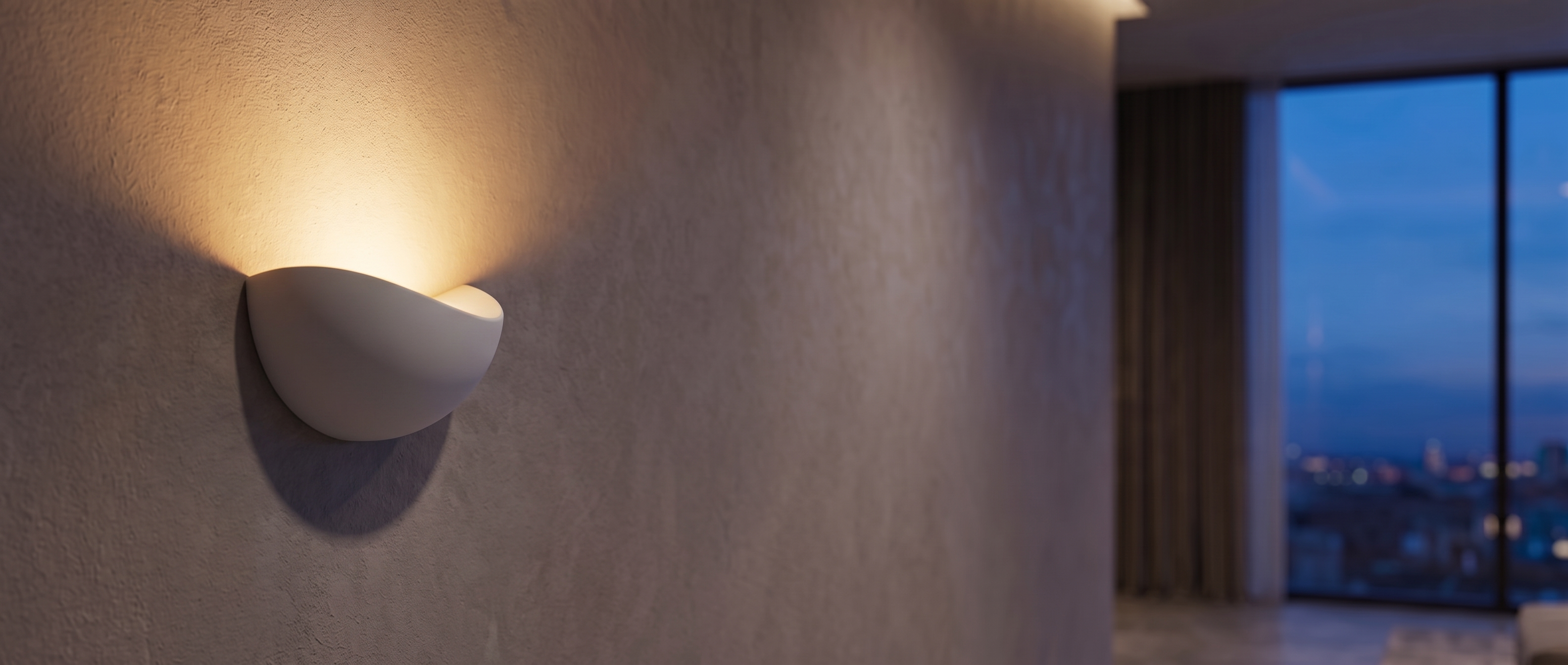 White Mezzaluna sconce glowing upward beside a city-view window at dusk