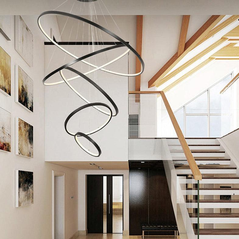 Black LED ring chandelier in a double-height foyer with staircase