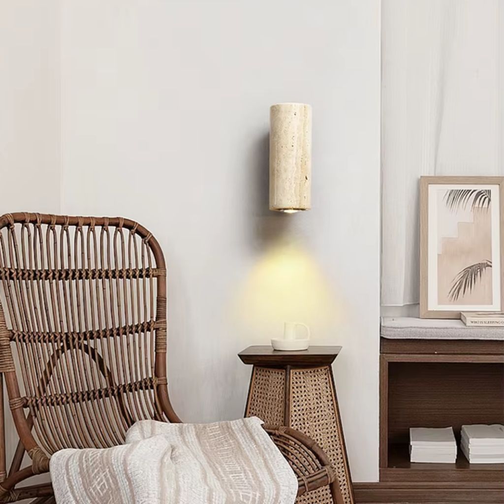 https://cdn.shopify.com/s/files/1/0655/0464/1076/files/stoneshine-wabi-sabi-travertine-wall-lamp-next-to-chair.jpg?v=1773354937