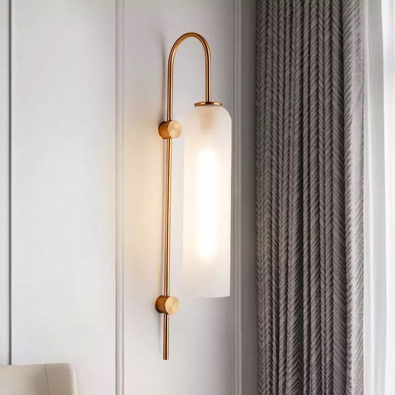 Frosted glass wall light with brass arm in an elegant bedroom