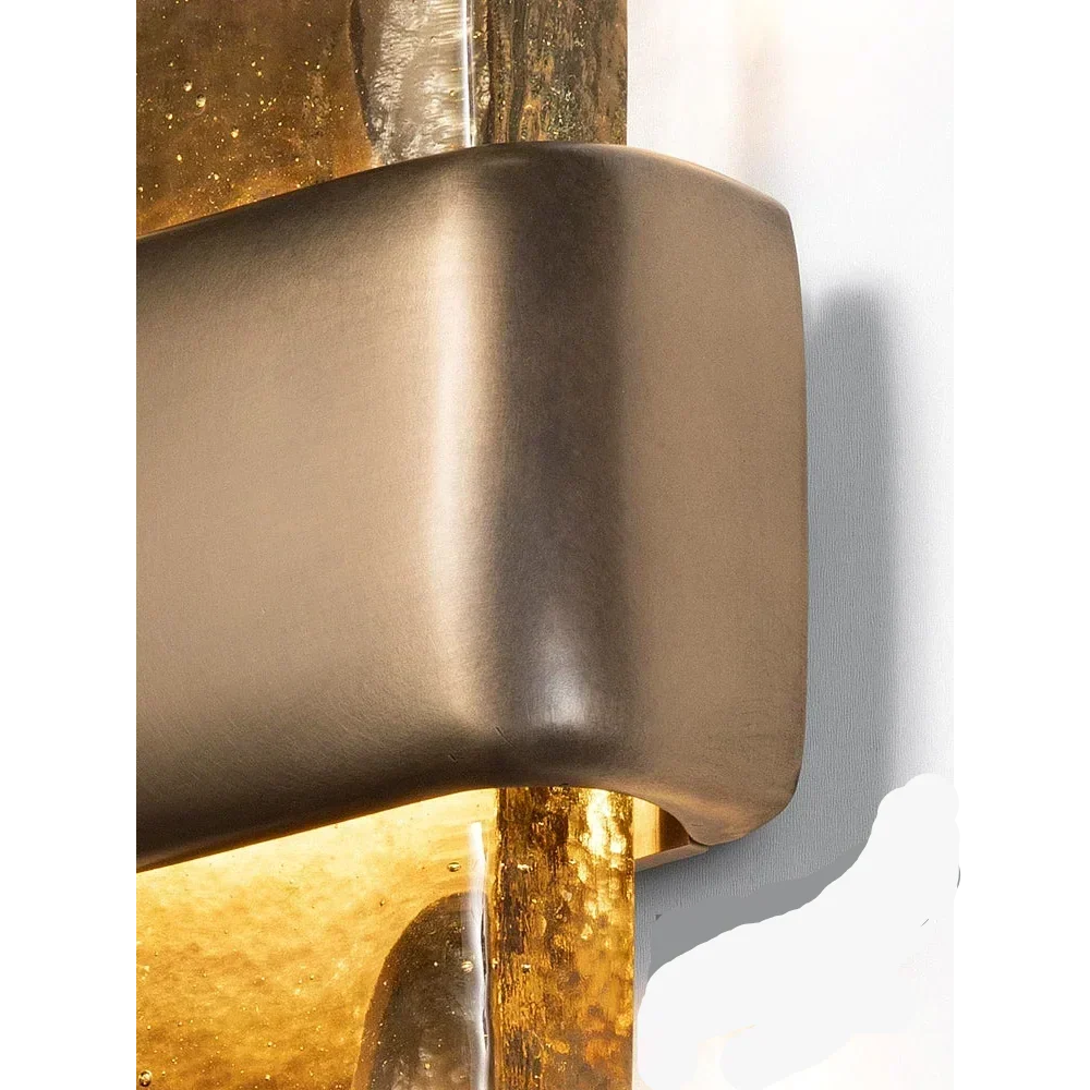 Close-up of the Vetro Colato satin bronze brass band and glowing cast glass