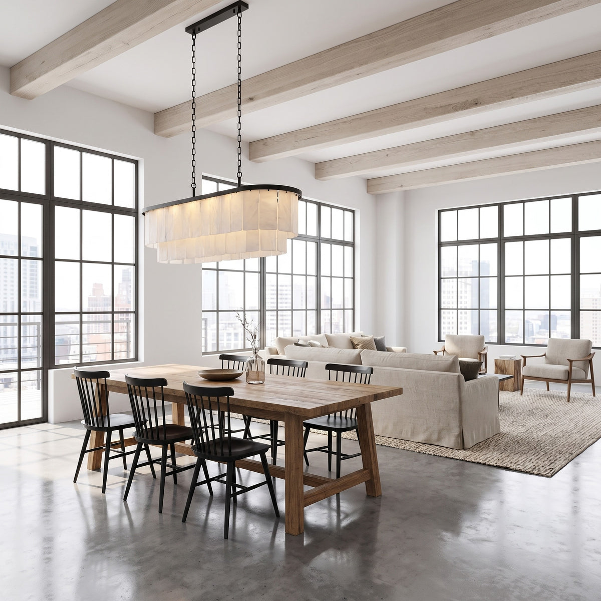 Velo Alabastro linear chandelier over a rustic oak dining table in a bright open-plan loft