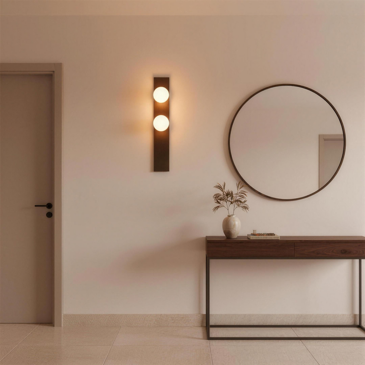 Alabaster wall sconce beside a round mirror above a console in an entrance hall