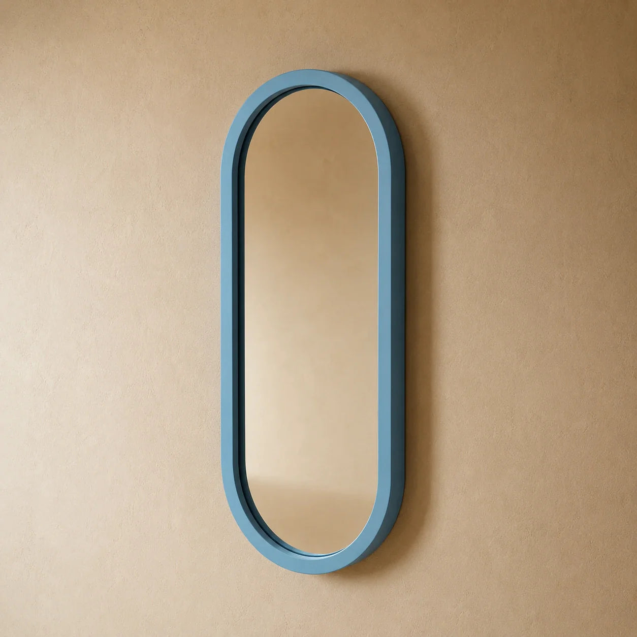 Ovale Azzurro dusty-blue capsule wall mirror styled in a room