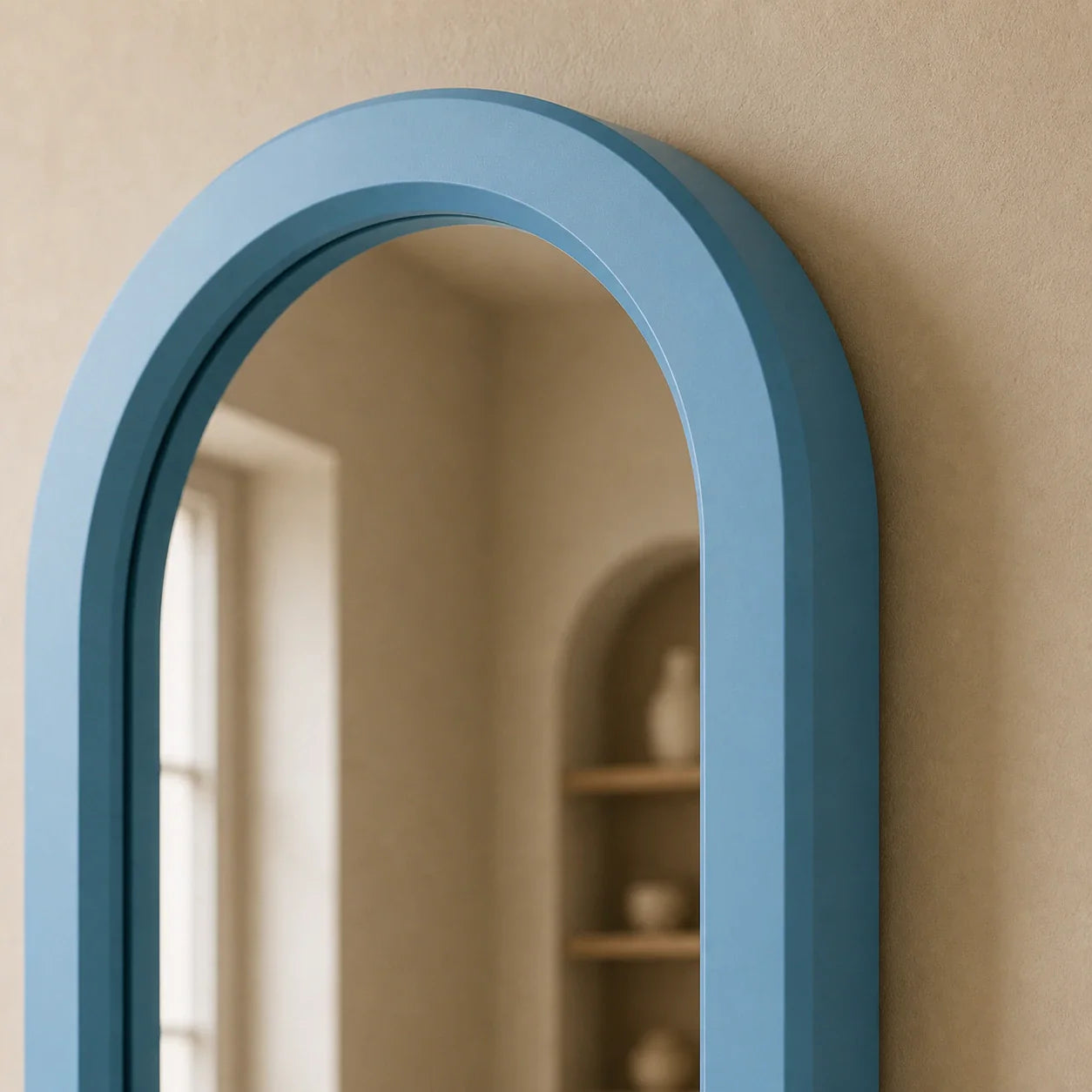Close detail of the dusty-blue hand-lacquered wood mirror frame