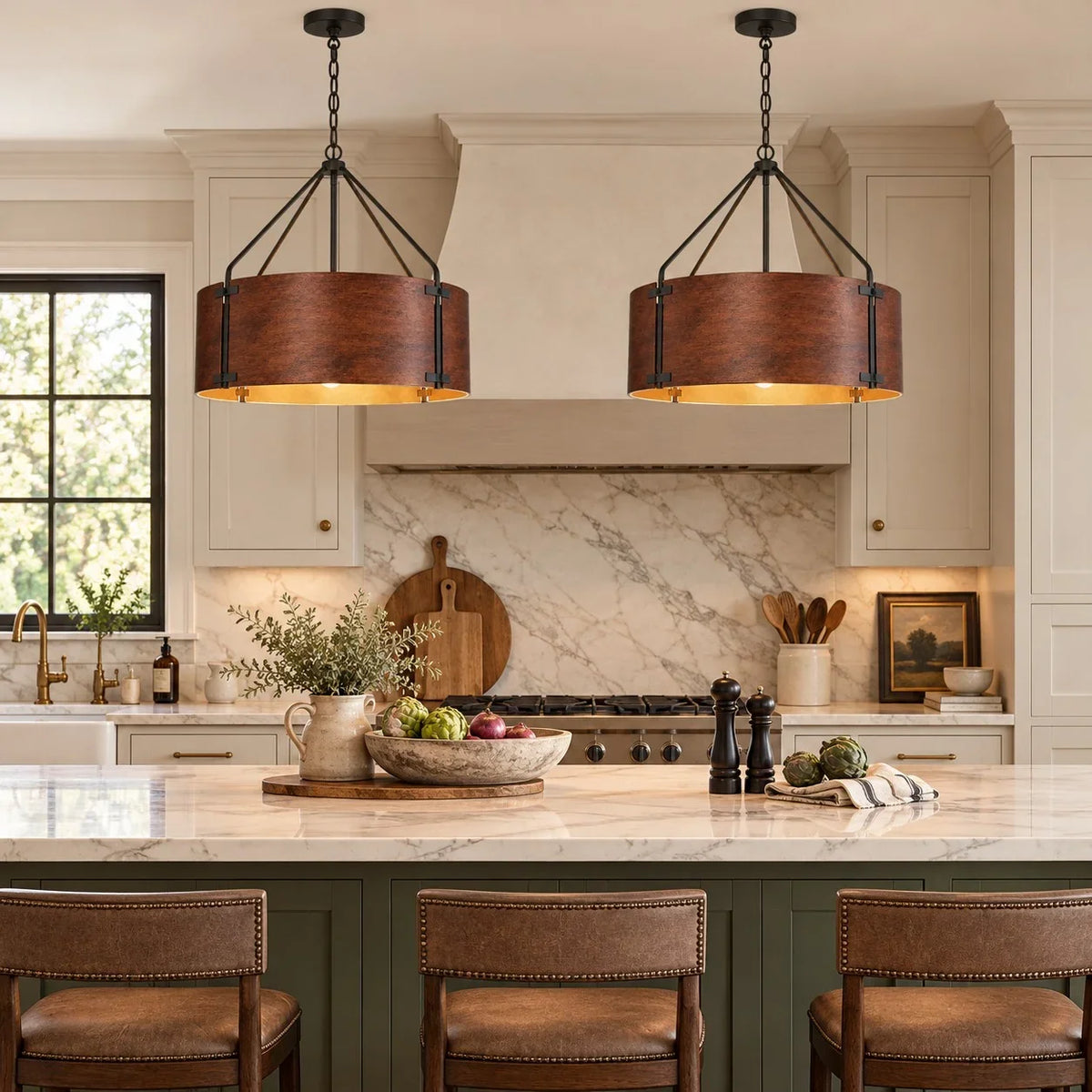 Pair of Tamburo bronze drum chandeliers over a kitchen island