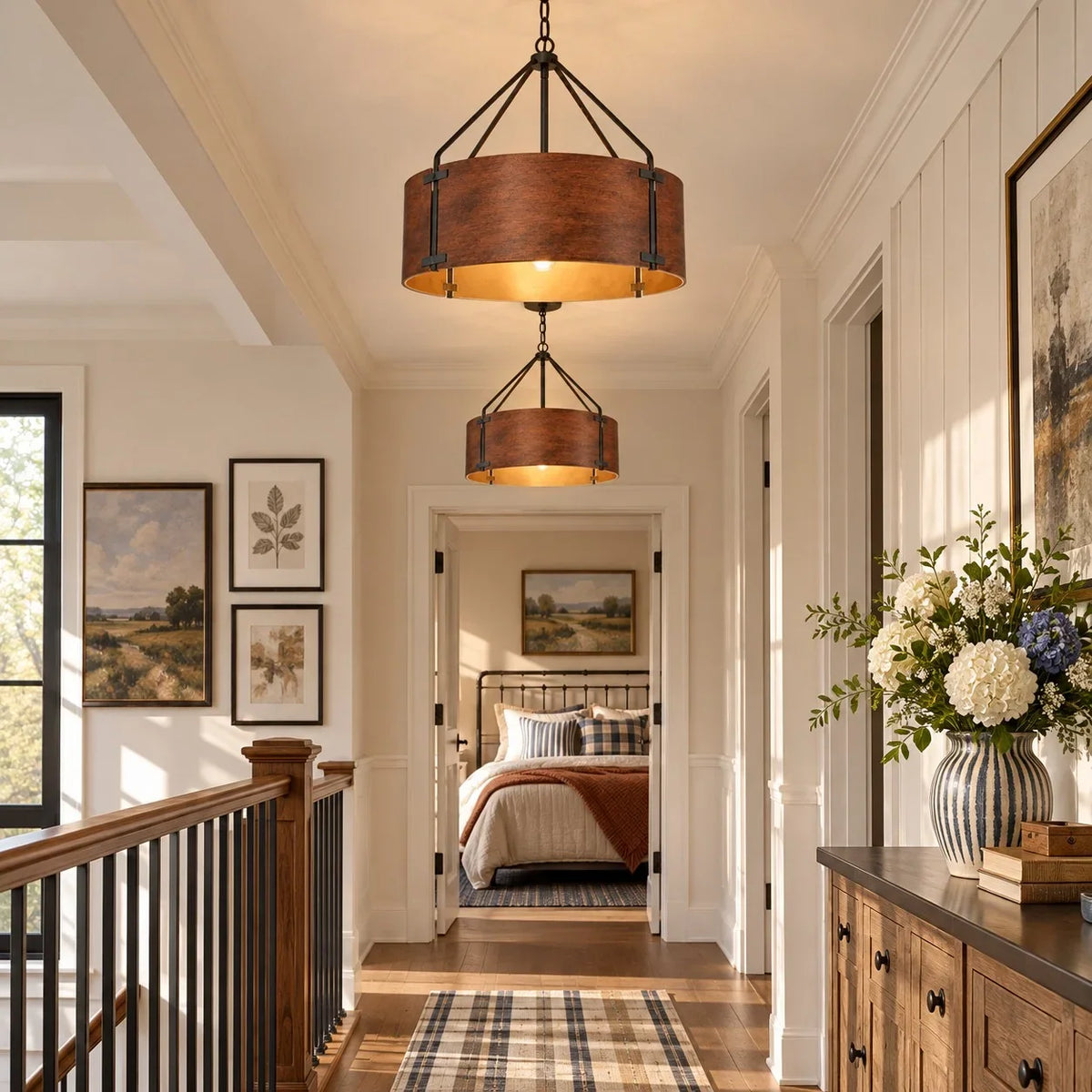Tamburo bronze drum chandeliers lighting an upstairs hallway