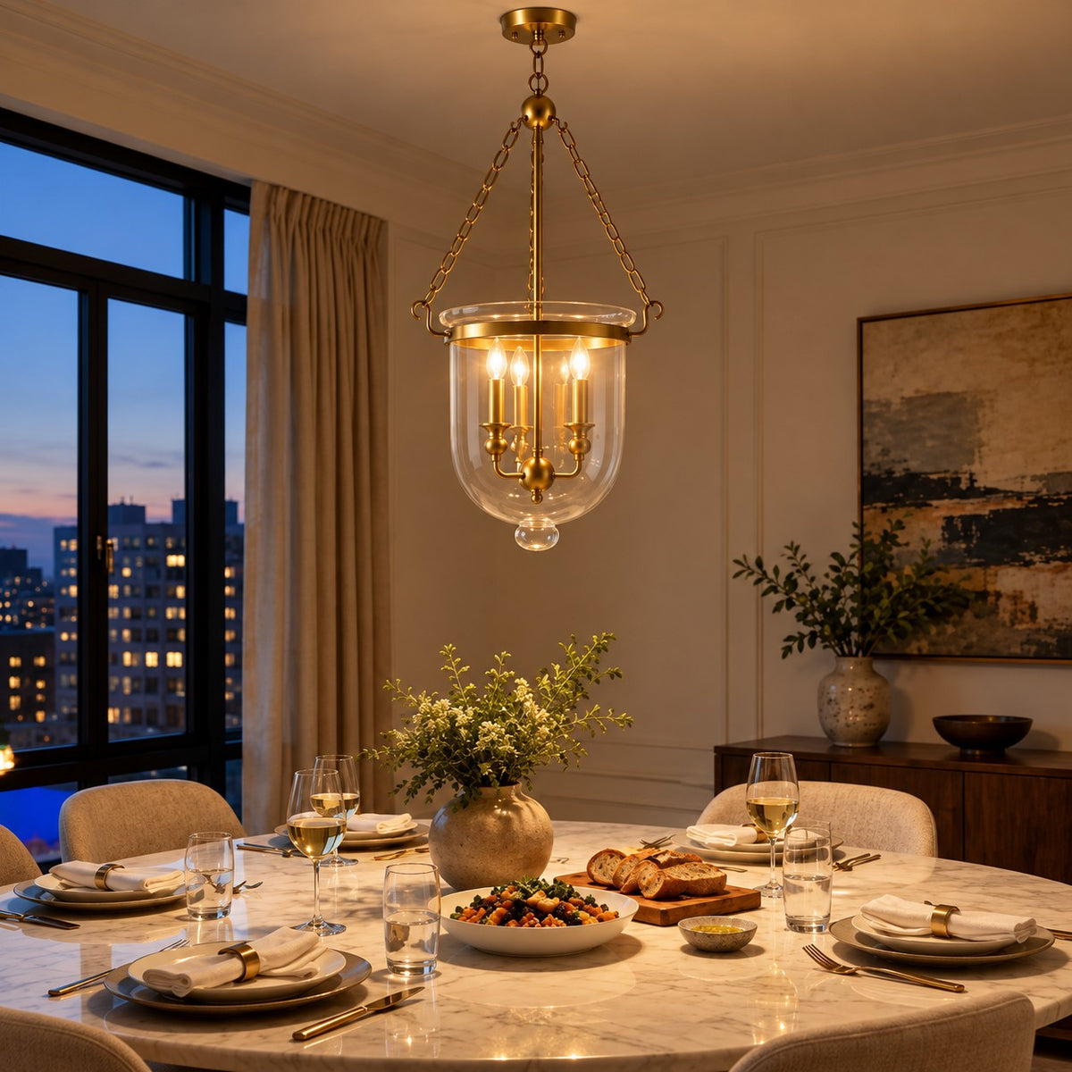 Brass bell jar pendant over a dining table at dusk