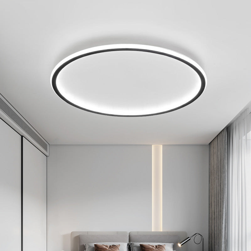 Luce Aurora black halo ceiling light in a bright modern bedroom