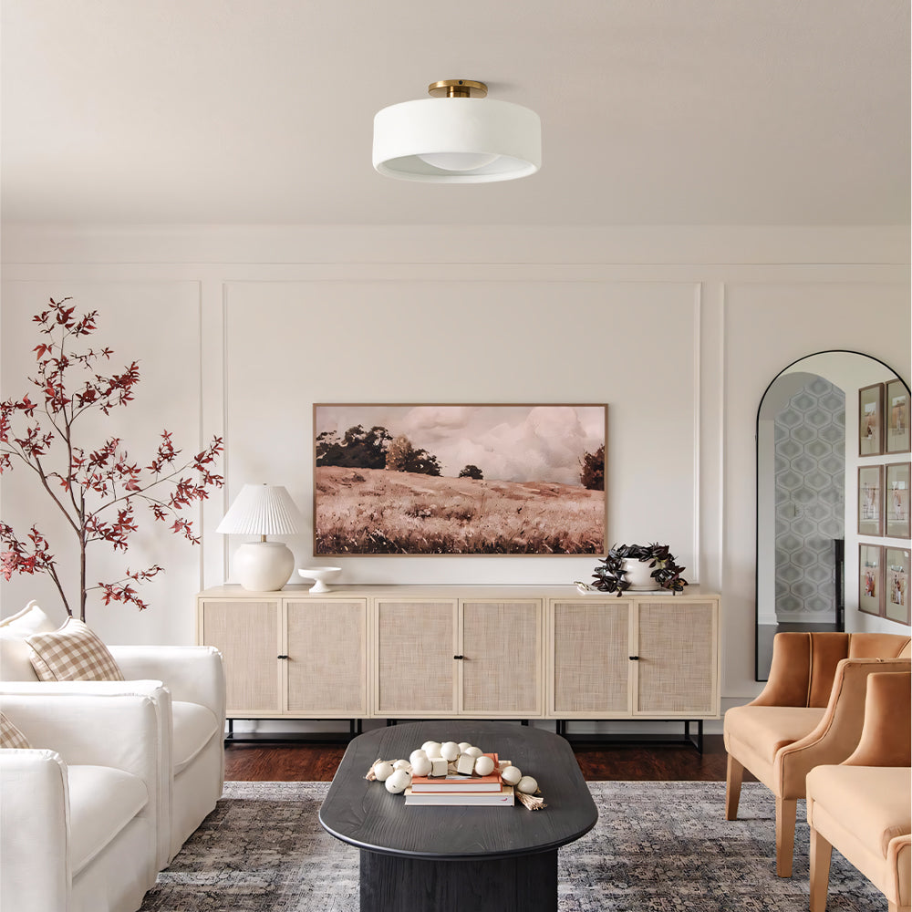 White porcelain semi-flush ceiling light in a bright living room with gallery wall