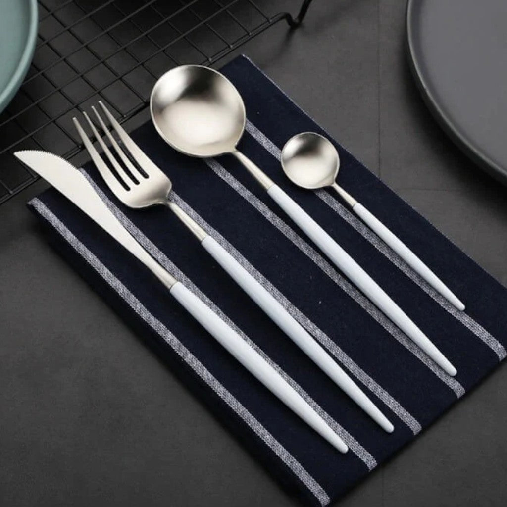 White and silver cutlery on a navy napkin