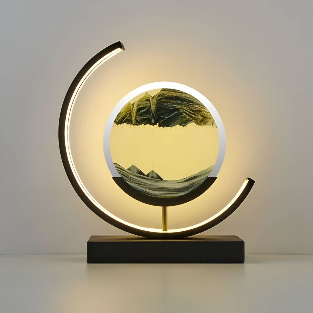 Black and gold sand art lamp glowing, product view