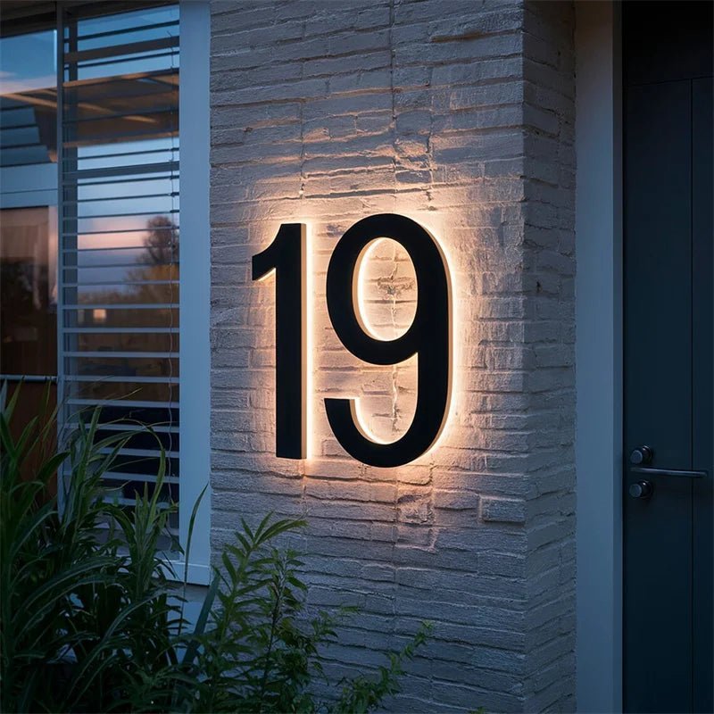 Illuminated house number 19 on a brick pillar