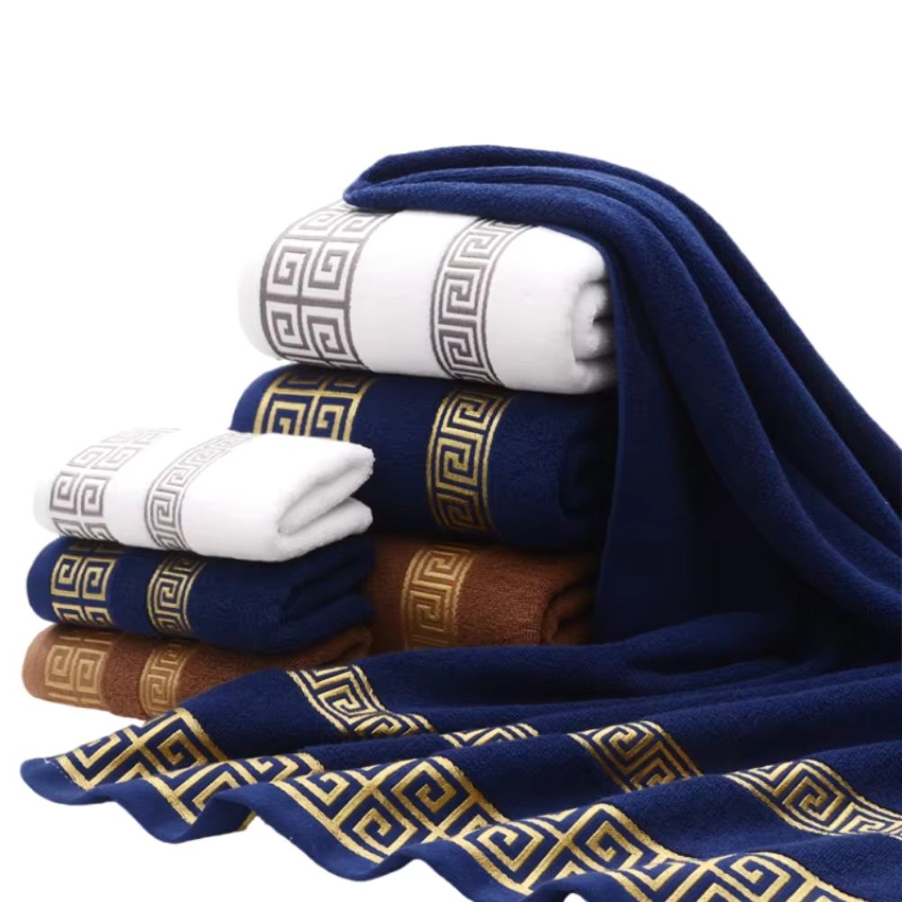 White and navy Greek key cotton towels stacked and draped