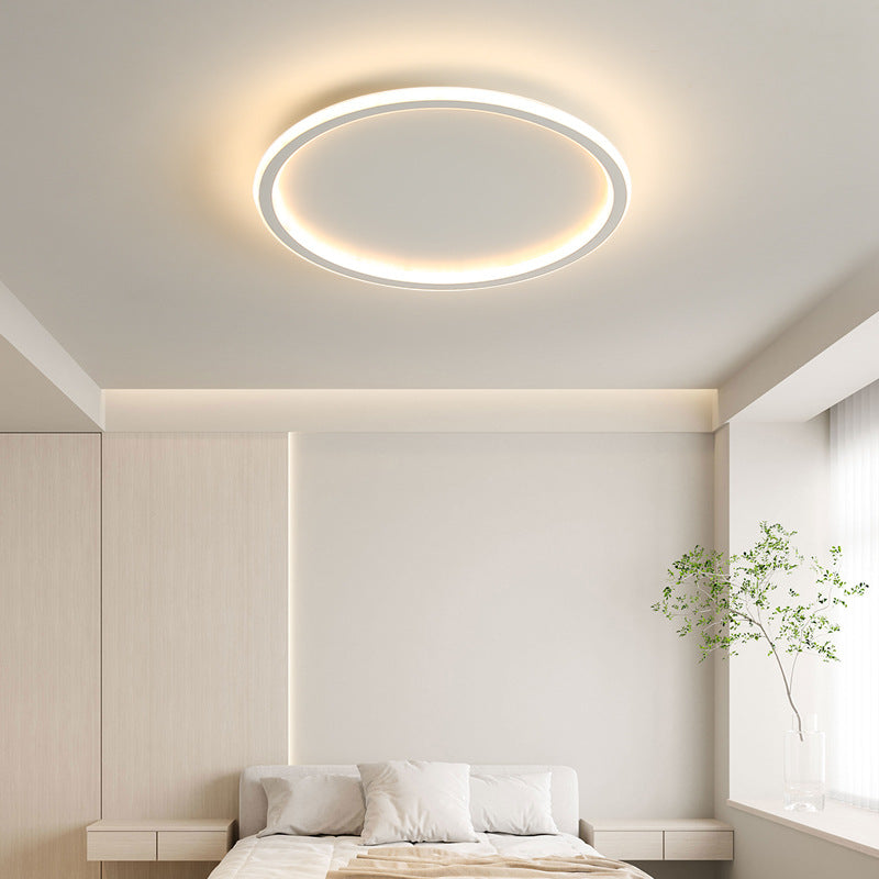 Luce Aurora white halo ceiling light in a minimalist bedroom