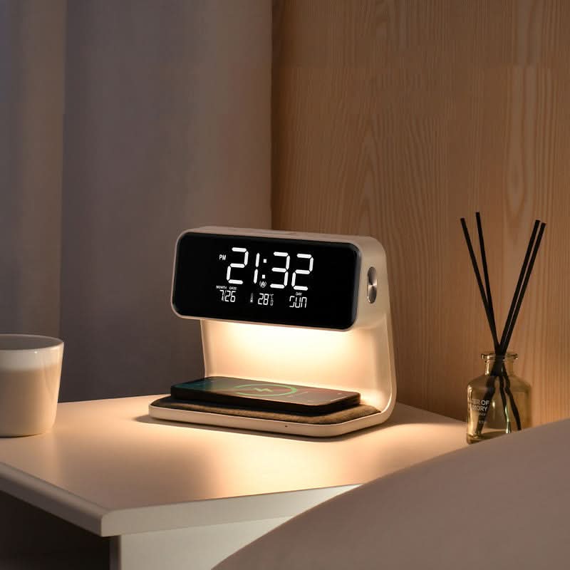Aurora bedside station with warm night light glowing, phone charging beside a diffuser