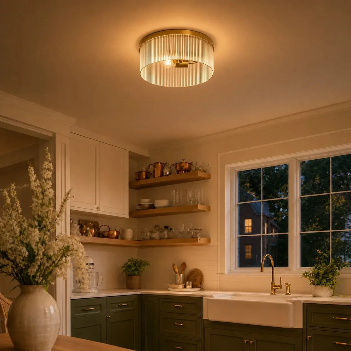 Tumbled brass ribbed glass flush mount glowing in a green farmhouse kitchen at dusk