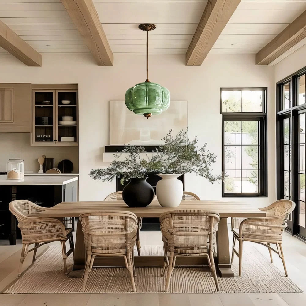 Green fluted glass semi-flush pendant above a dining table under oak ceiling beams