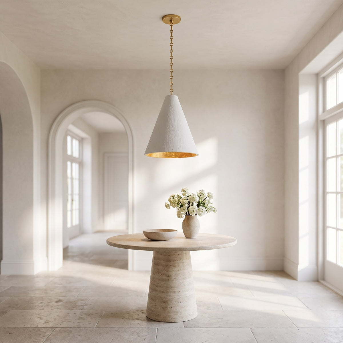 Calma Gessata plaster cone pendant above a round travertine table in a bright entrance hall